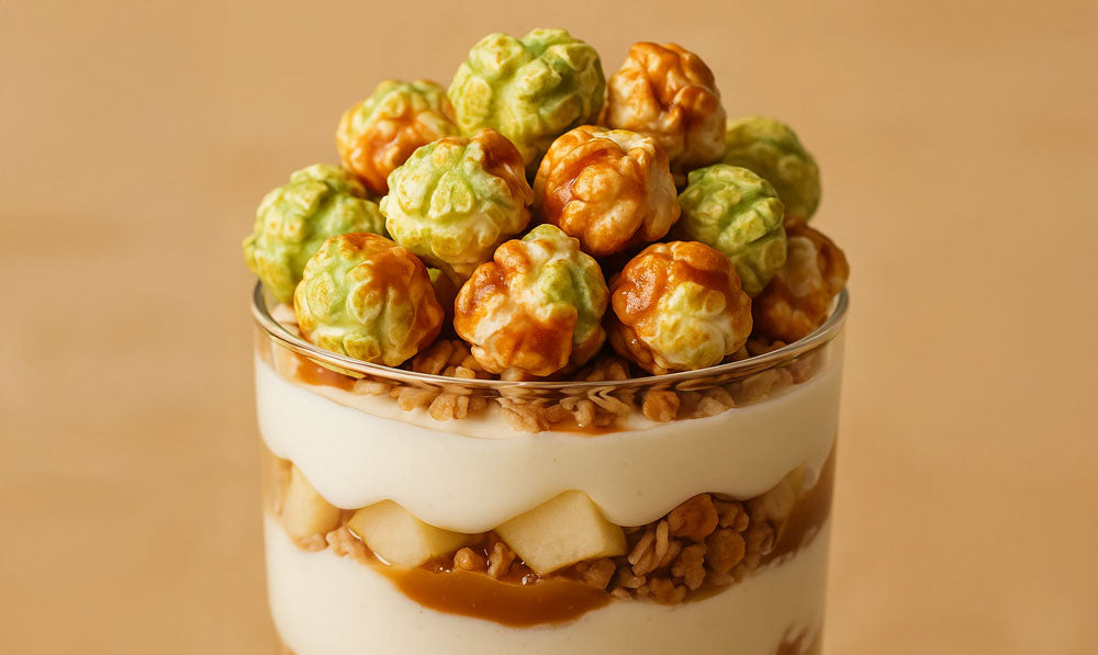 Toffee Apple Pop Yum Parfait recipe featuring layers of yogurt, granola, apples, and colourful popcorn on top.