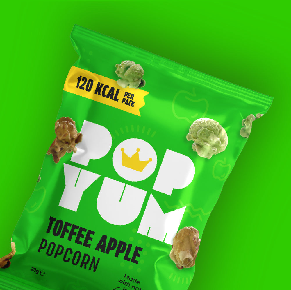 A green packet of Pop Yum Toffee Apple popcorn on a green background. 120 kcal per pack is also displayed.