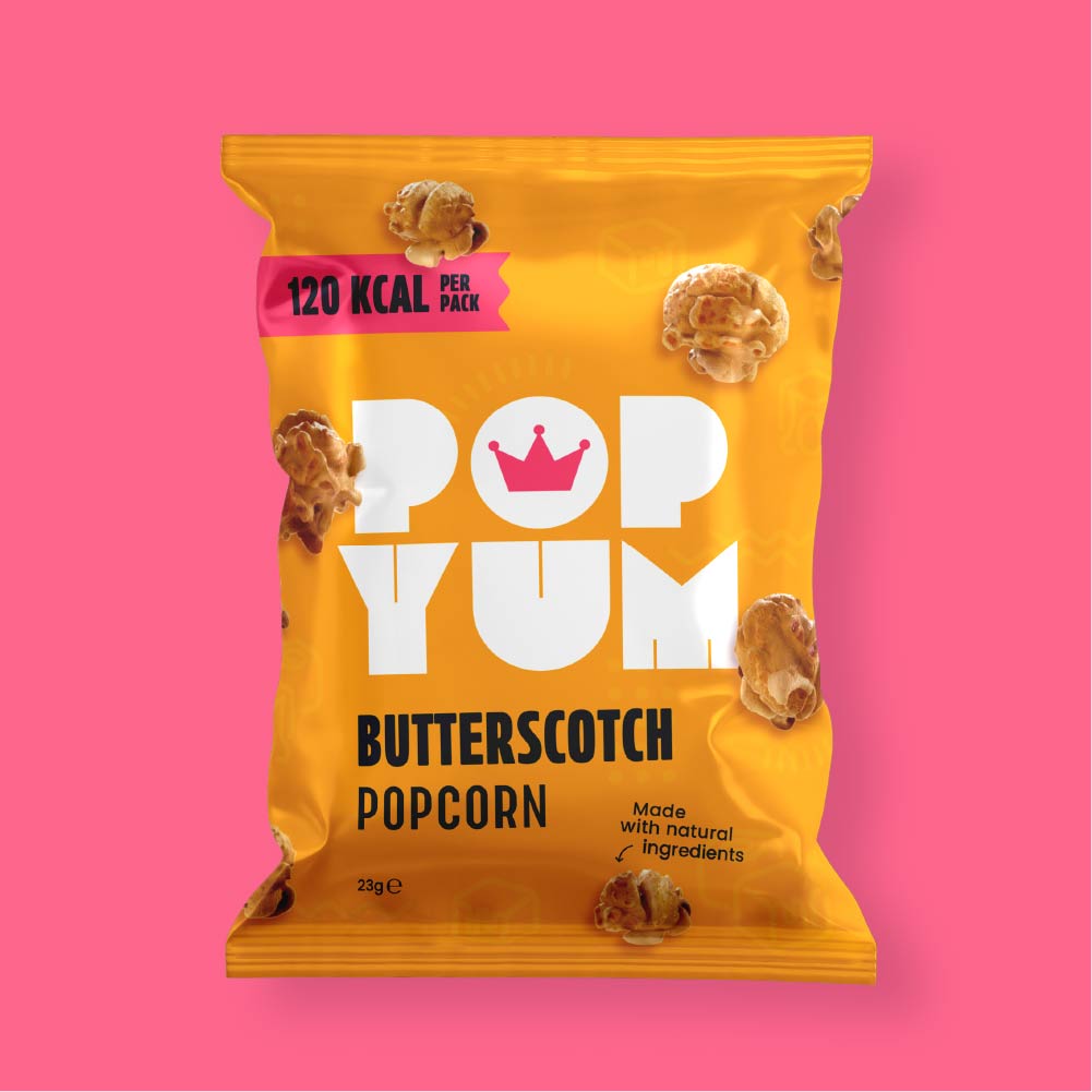Close-up of a yellow packet of Pop Yum butterscotch-flavoured low-calorie popcorn on a pink background.