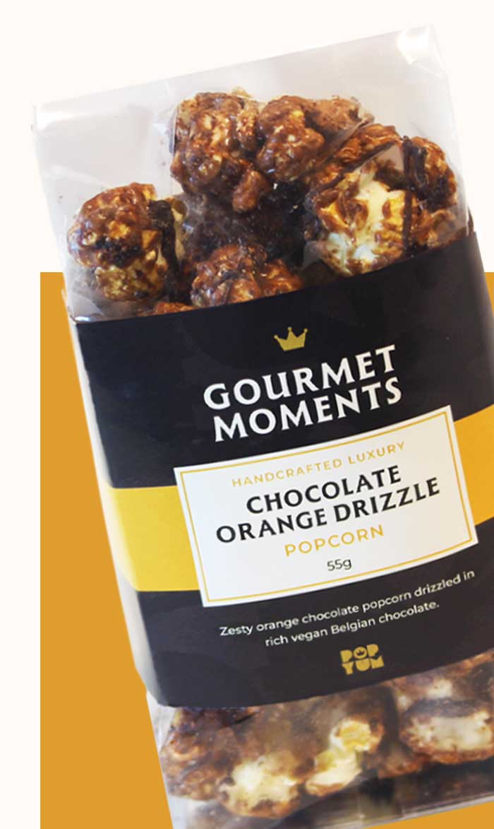 Packaged Gourmet Moments Chocolate Orange Drizzle popcorn on a white background.
