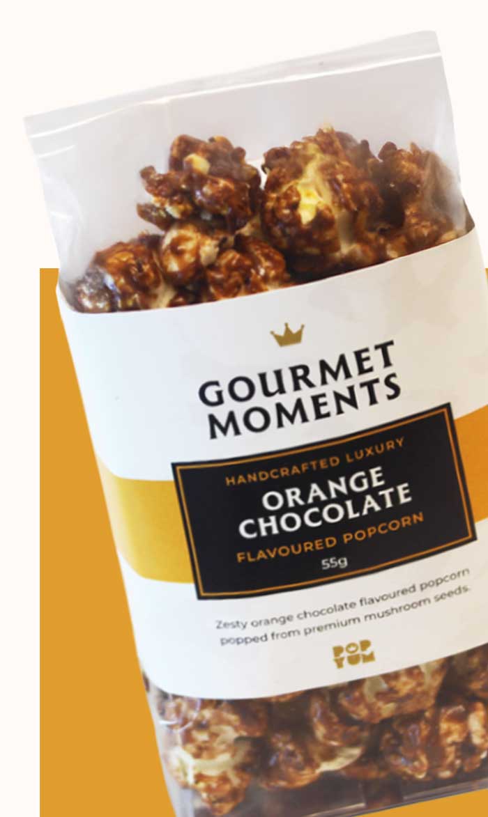 Packaged Gourmet Moments Orange Chocolate flavoured popcorn on a white background.