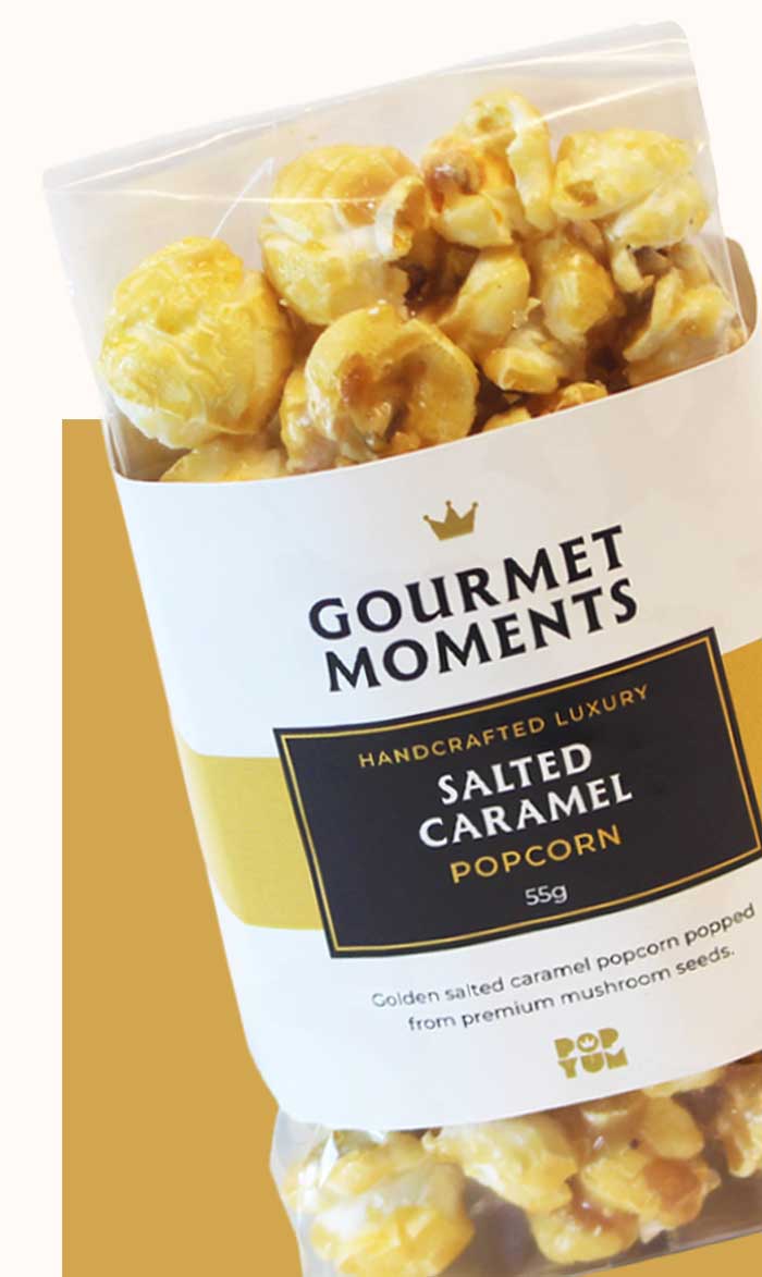 Packaged Gourmet Moments Salted Caramel popcorn on a gold background.
