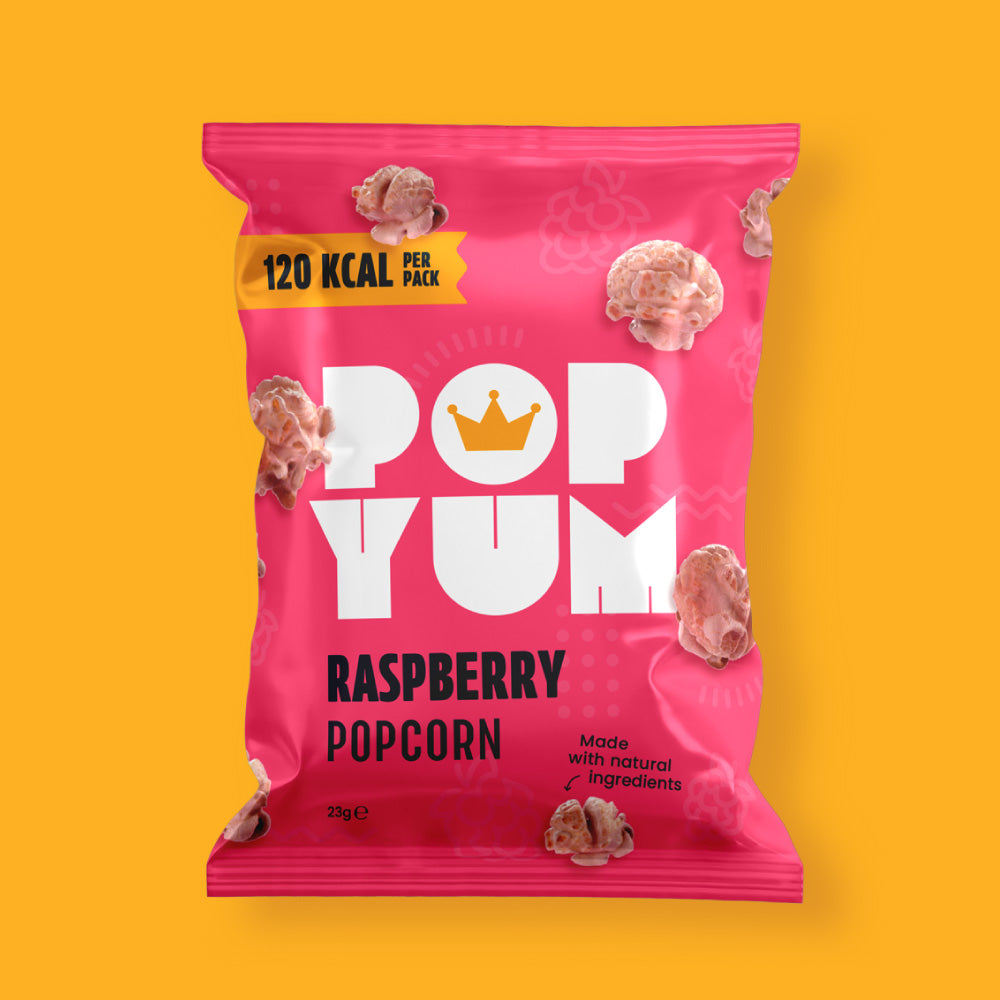 Pink bag of the Pop Yum raspberry-flavoured popcorn dairy-free snack on a yellow background.