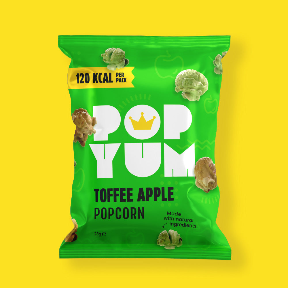 Green package of Pop Yum toffee apple flavoured popcorn on a yellow background.
