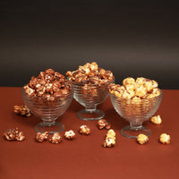 Vegan Belgian chocolate drizzled popcorn in elegant glass bowls showcasing 7 refined flavours.