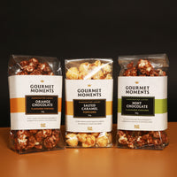 Vegan Belgian chocolate drizzled popcorn hamper featuring orange chocolate, salted caramel, and mint chocolate flavours.