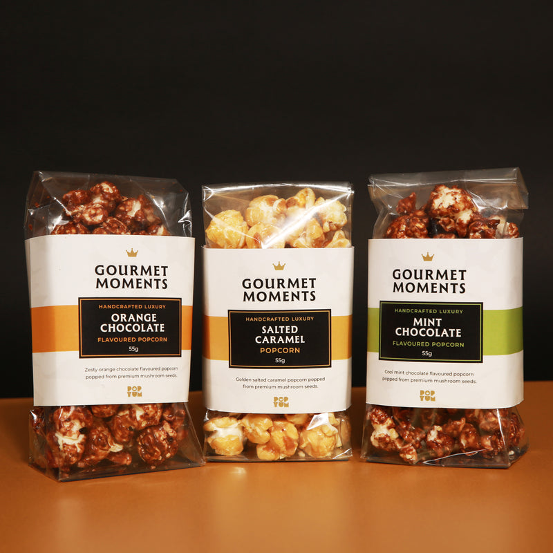 Vegan Belgian chocolate drizzled popcorn hamper featuring orange chocolate, salted caramel, and mint chocolate flavours.